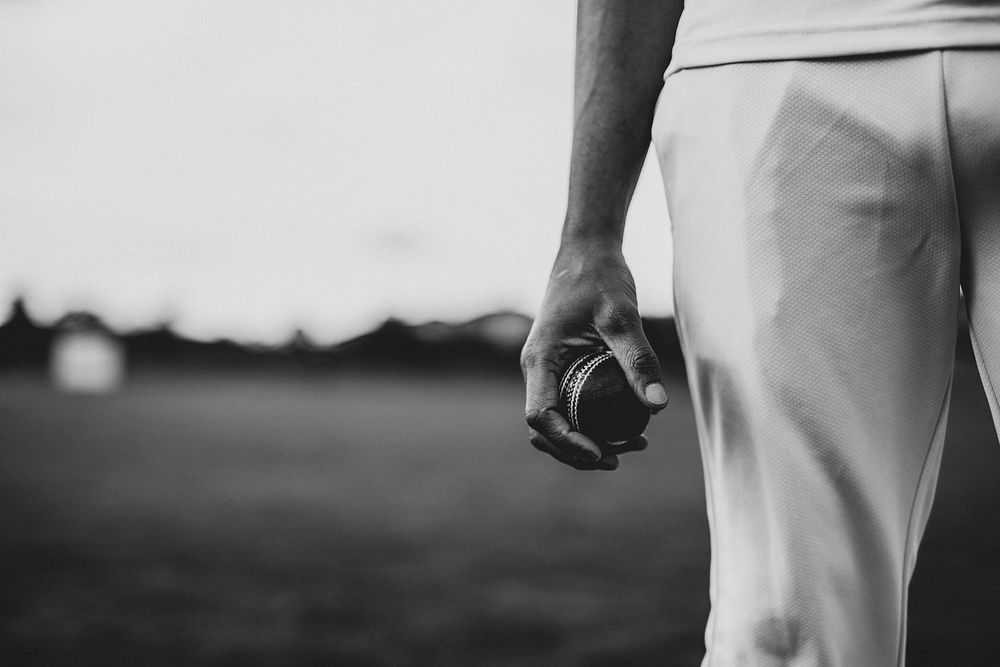 Cricket player holding a leather ball