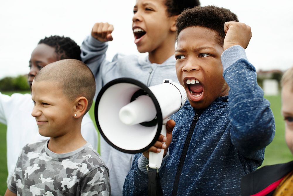 Young boy shouting on a megaphone in a protest