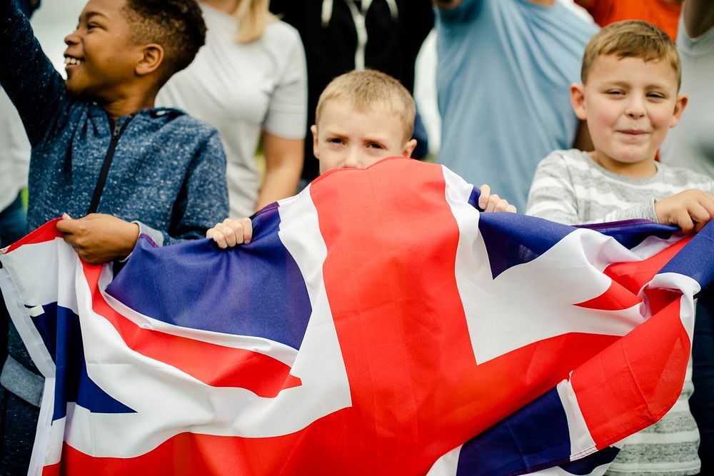 Group of diverse kids showing a UK flag in a protest