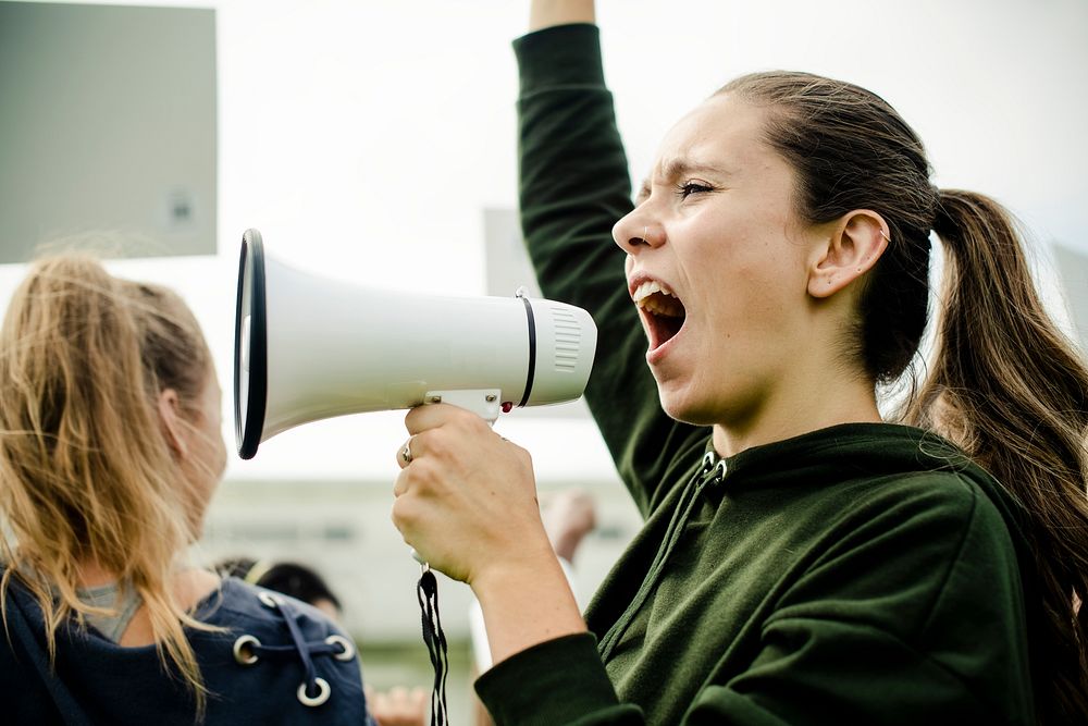 Female activist shouting on a megaphone
