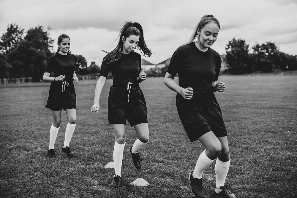 Female football players training on the field