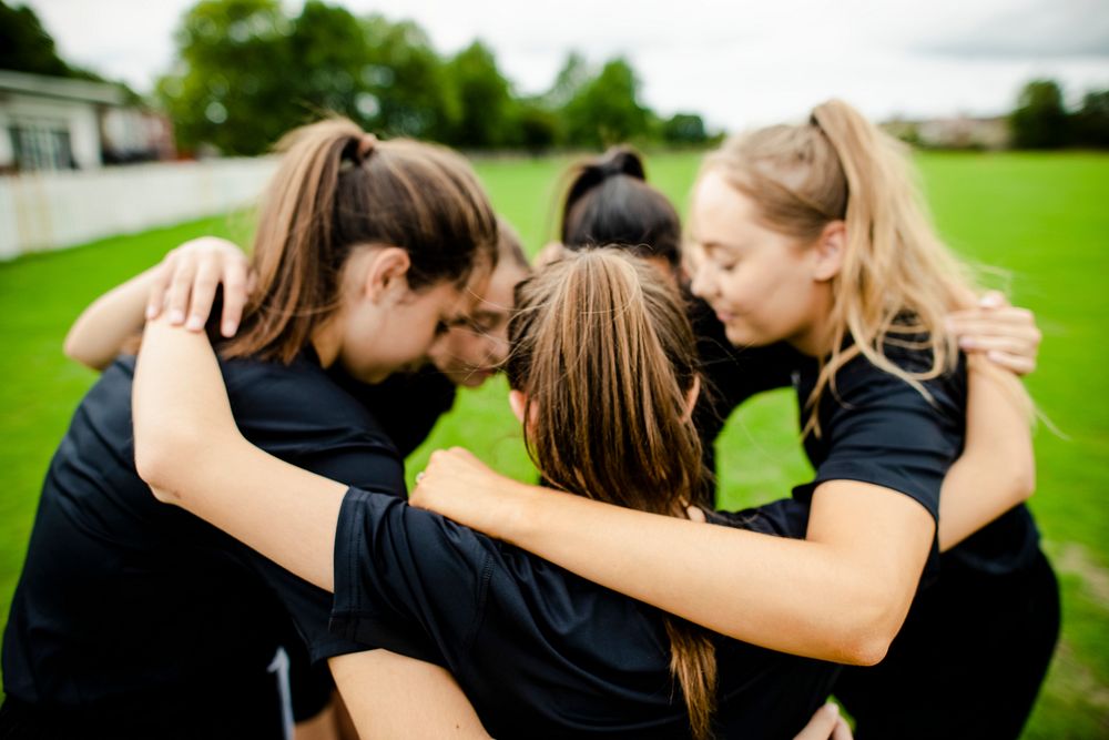 Rugby players huddle before a match