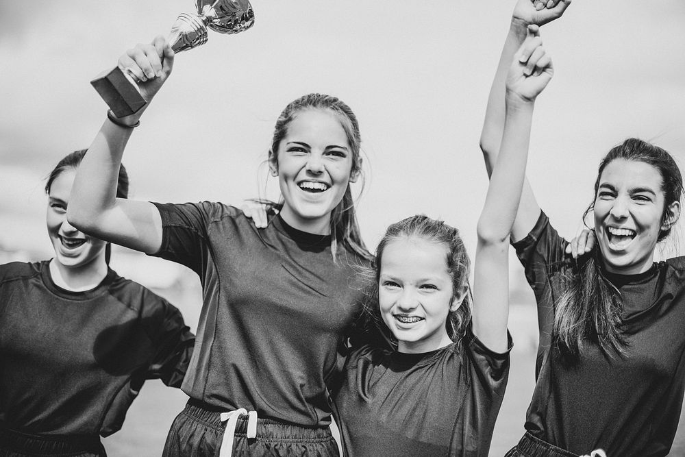 Young female football players celebrating their victory