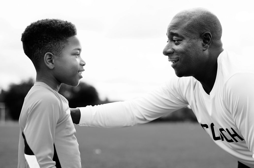 Football coach advising the goalkeeper