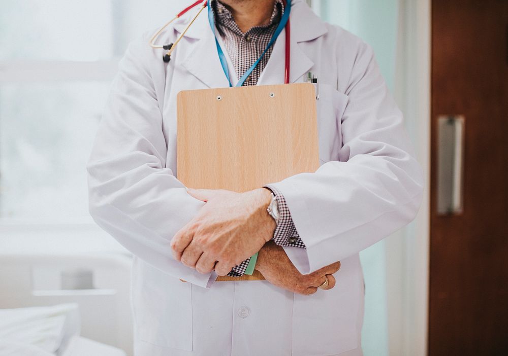 Physician holding a clipboard with medical information
