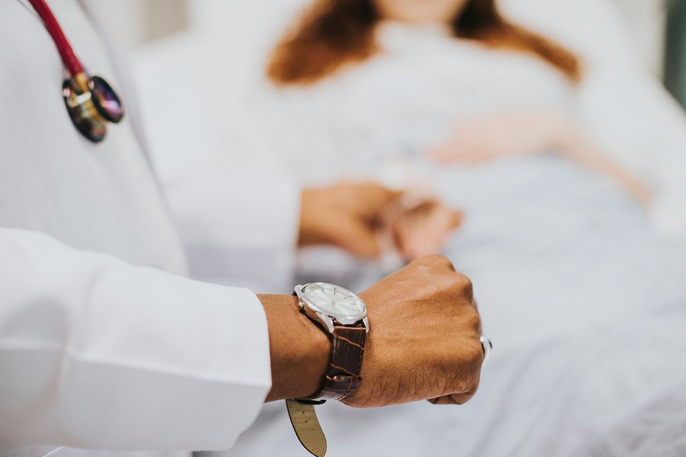 Physician checking her patients pulse