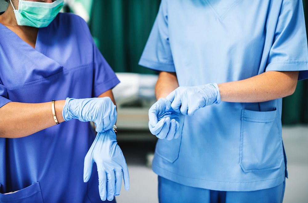 Surgeons wearing gloves preparing for surgery