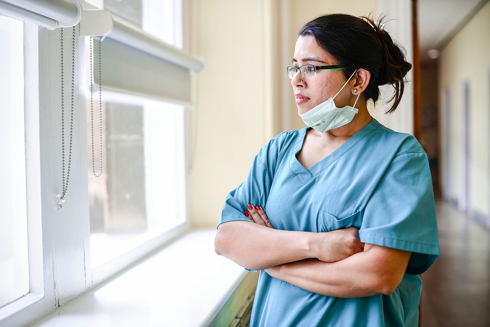 Female nurse staring out the window