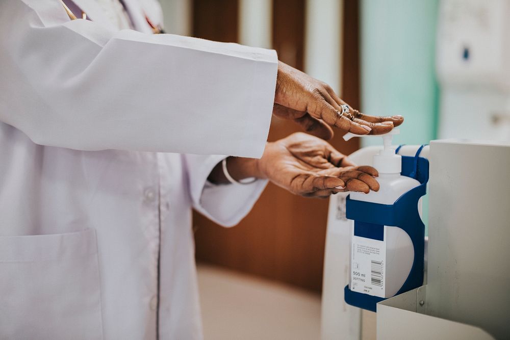 Female physician disinfecting her hands