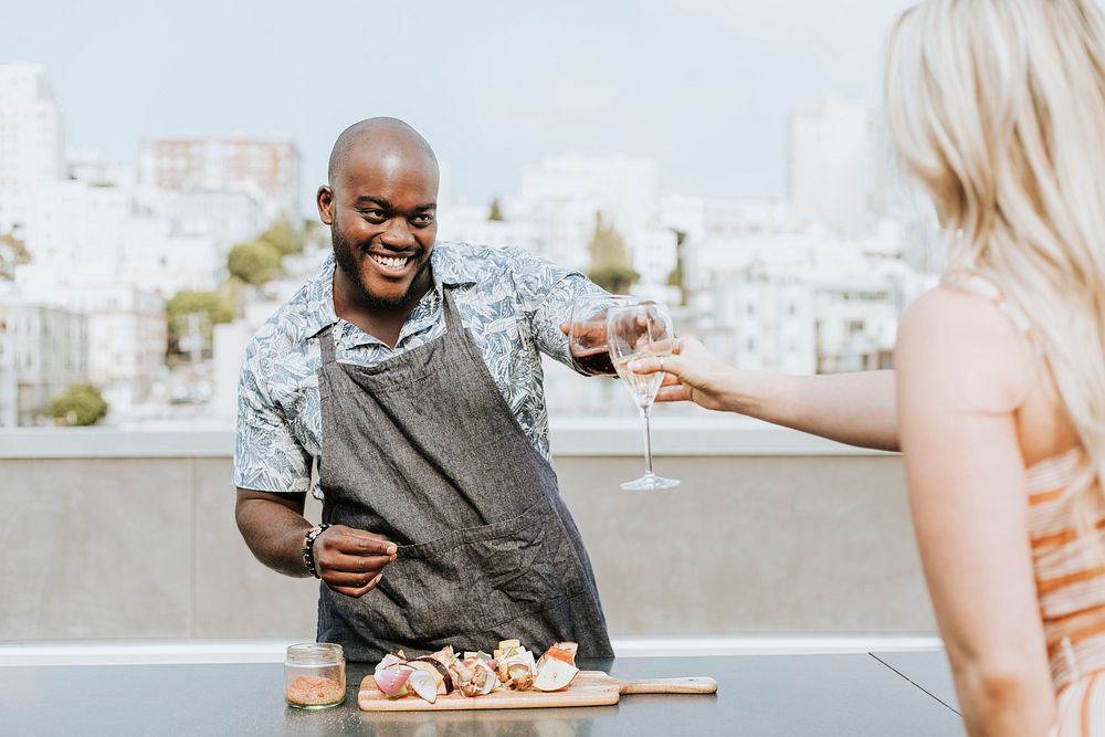 Chef toasting at a rooftop party