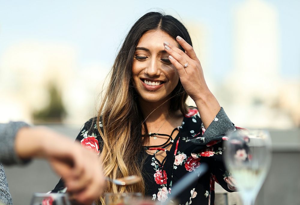 Cheerful woman enjoying a rooftop party with her friends