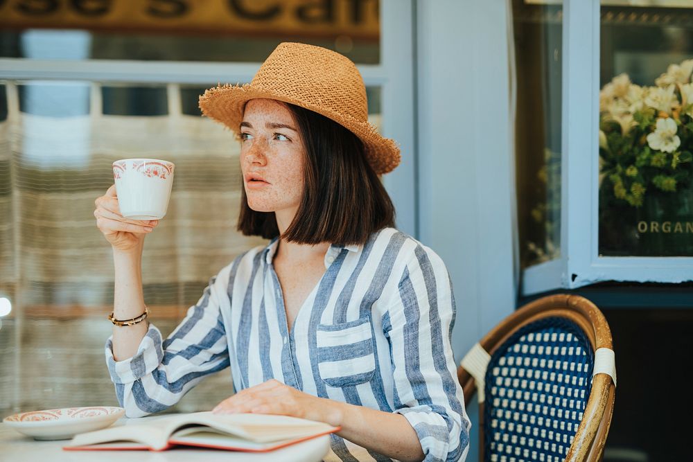 Woman reading a book at a cafe