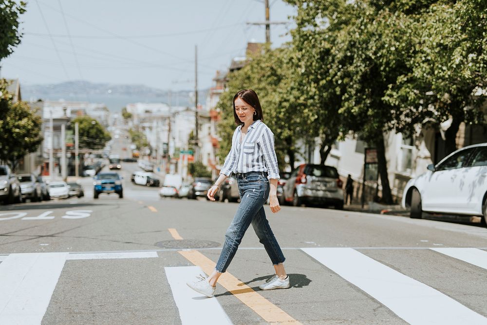 Casual woman crossing the street in downtown, San Francisco