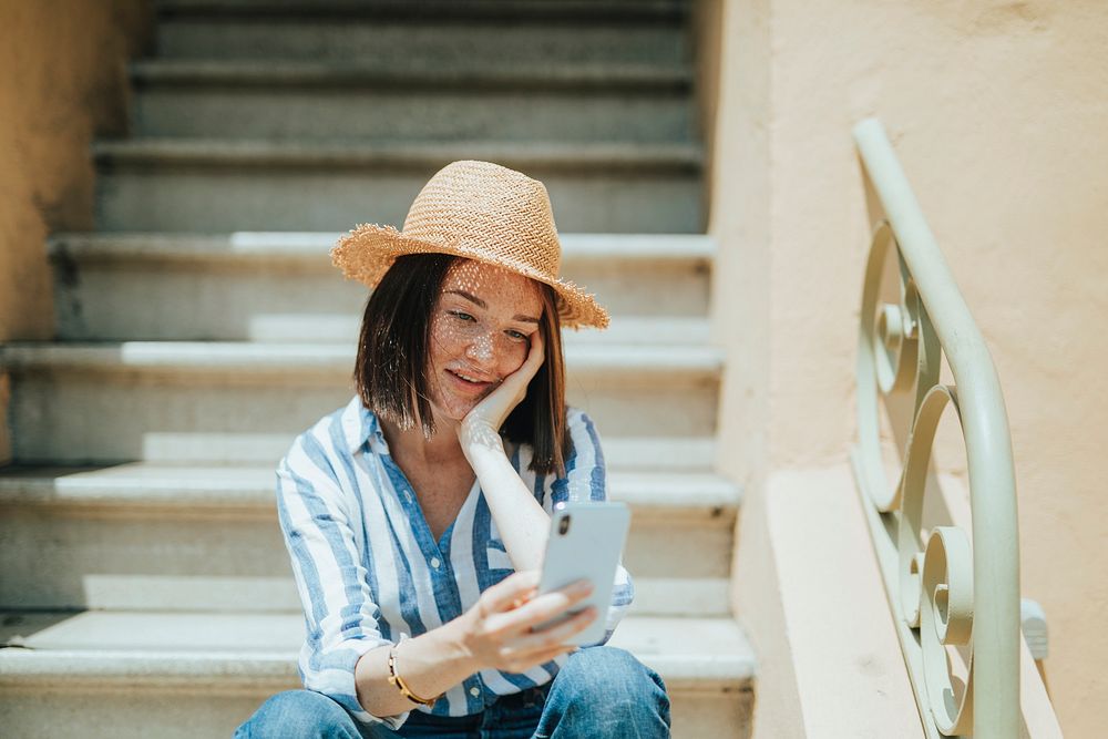 Happy woman using her phone