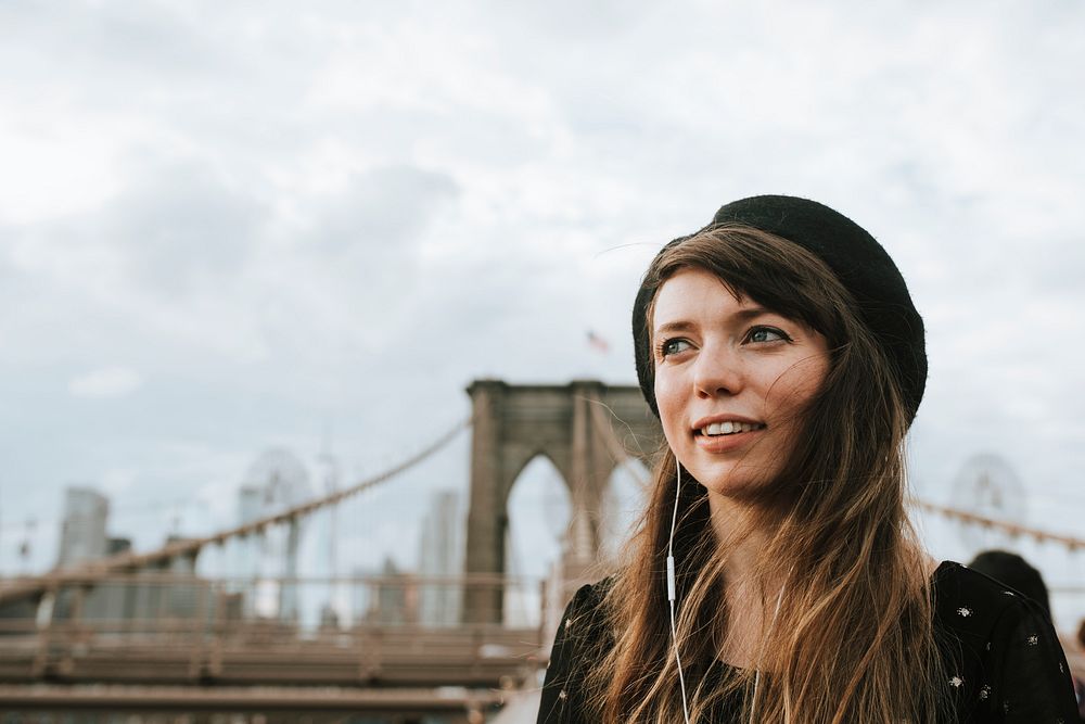 Woman listening to music on the Brooklyn Bridge, USA