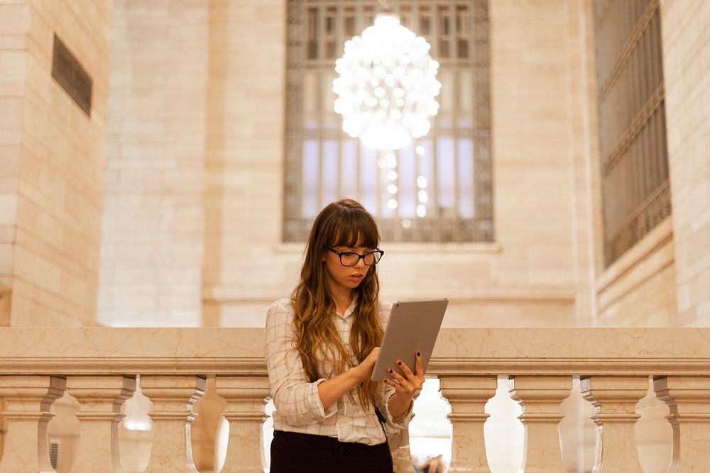 Woman using a digital tablet in the Grand Central Station