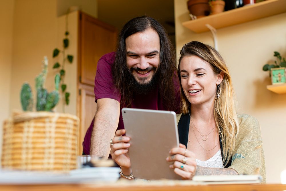 Couple using a digital tablet at home