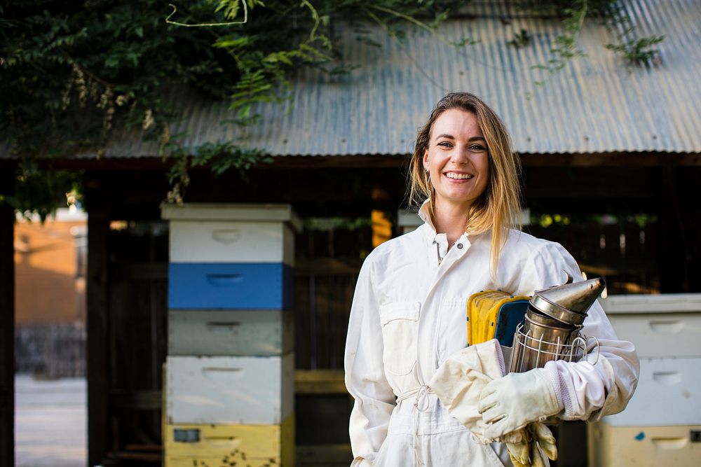 Beekeeper in front of her bee hives