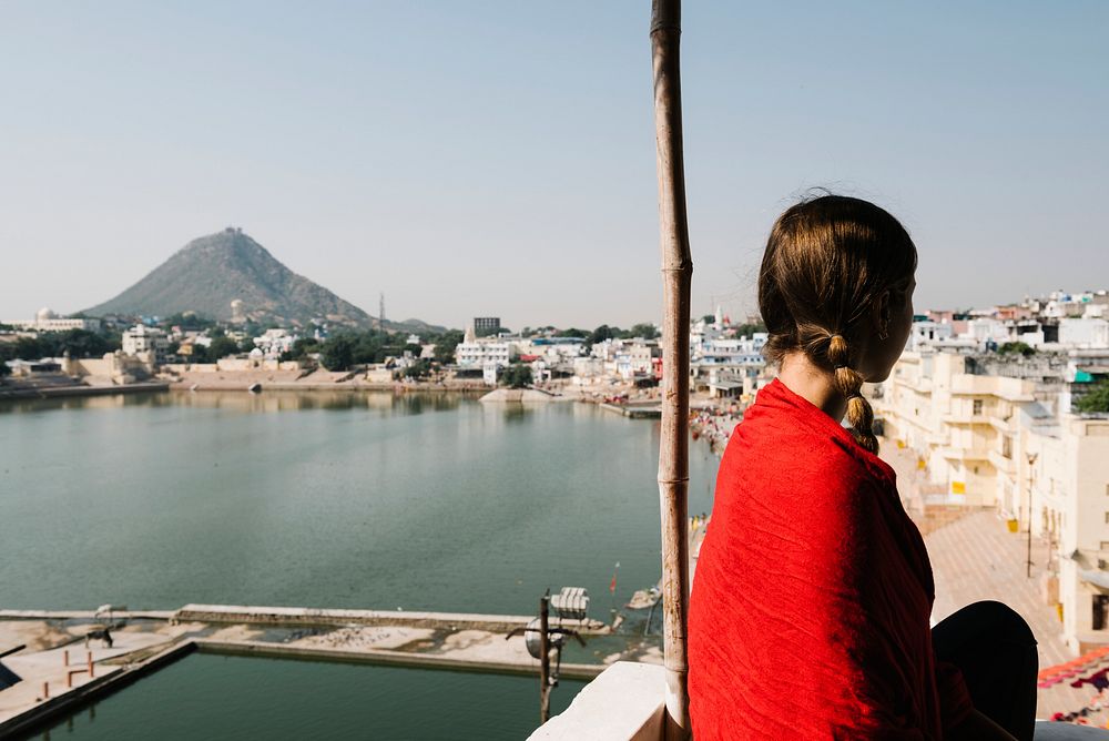 Western woman enjoying a view of Pushkar lake in Rajasthan