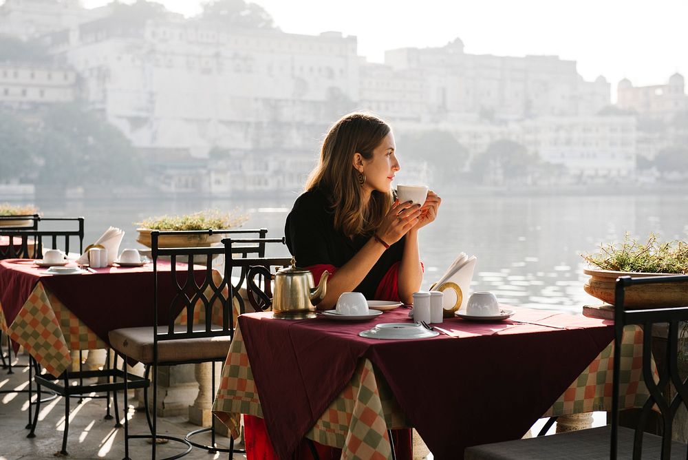 Western woman having a teatime at a cafe in Udaipur