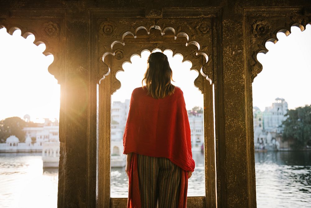 Western woman standing on a cultural architecture in Udaipur, India
