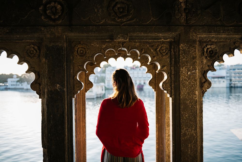 Western woman standing on a cultural architecture in Udaipur, India