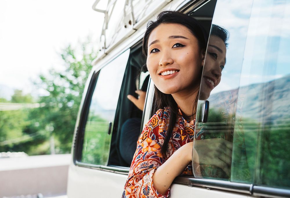 Happy woman enjoying the view from a van
