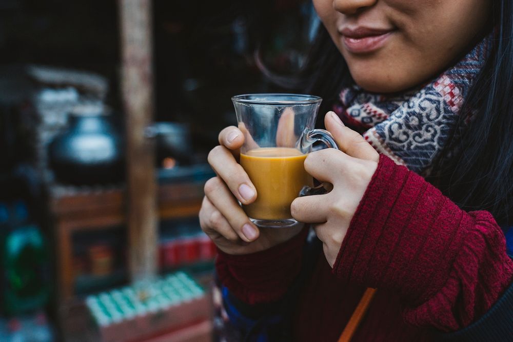 Woman with a warm cup of masala chai