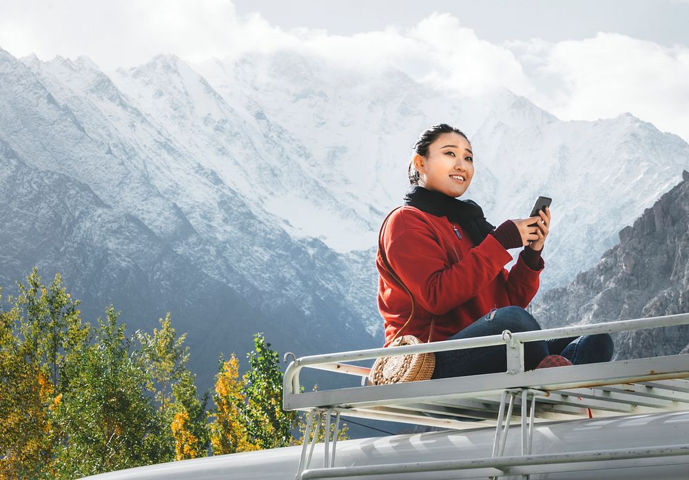 Woman using a smartphone in the Himalaya mountains