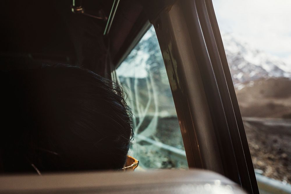 Woman asleep in the van during a road trip