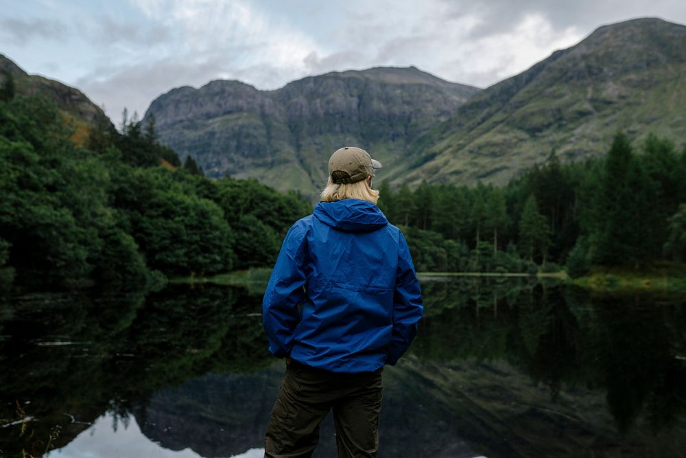 Man standing by the riverside in the Highlands