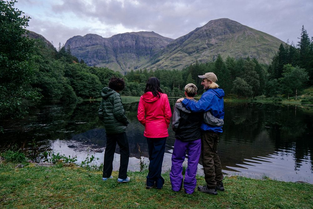 Friends relaxing by the riverside in the Highlands