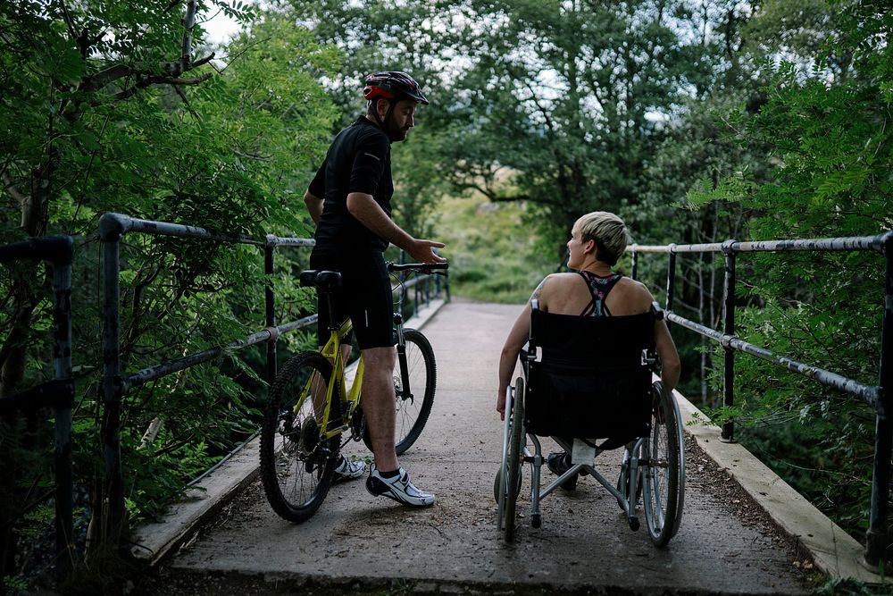 Couple exercising together on a bicycle and in a wheelchair