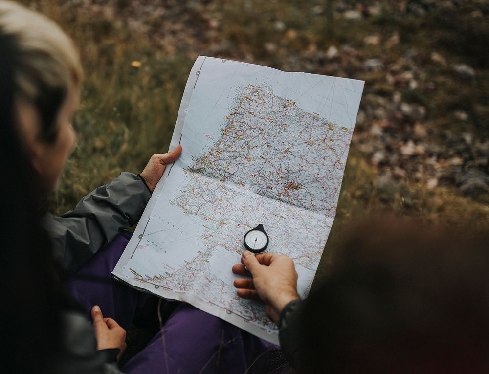 Hikers using a compass and a map