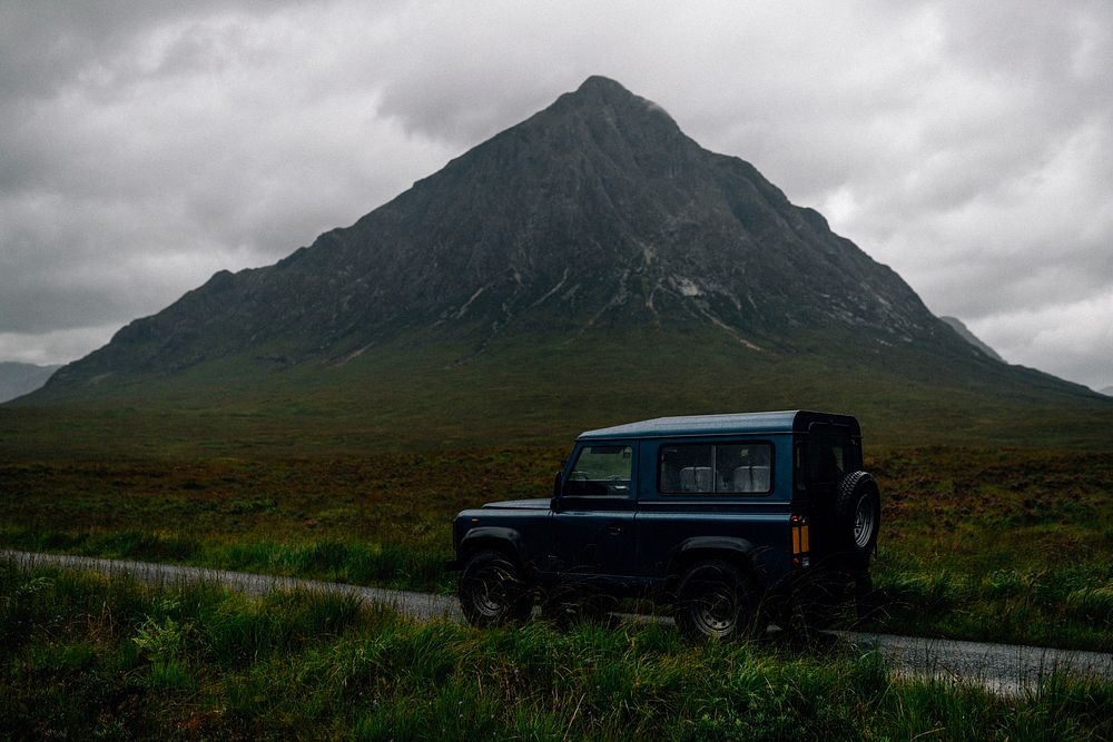 SUV on a road through the Scottish Highlands