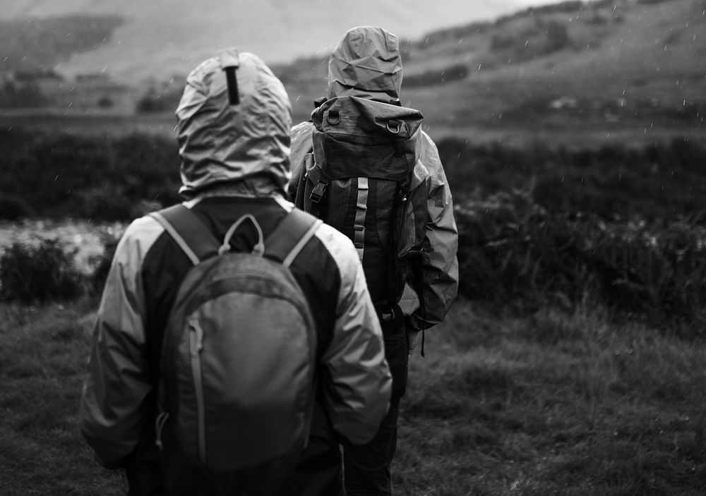 Couple trekking through the rain in the Highlands