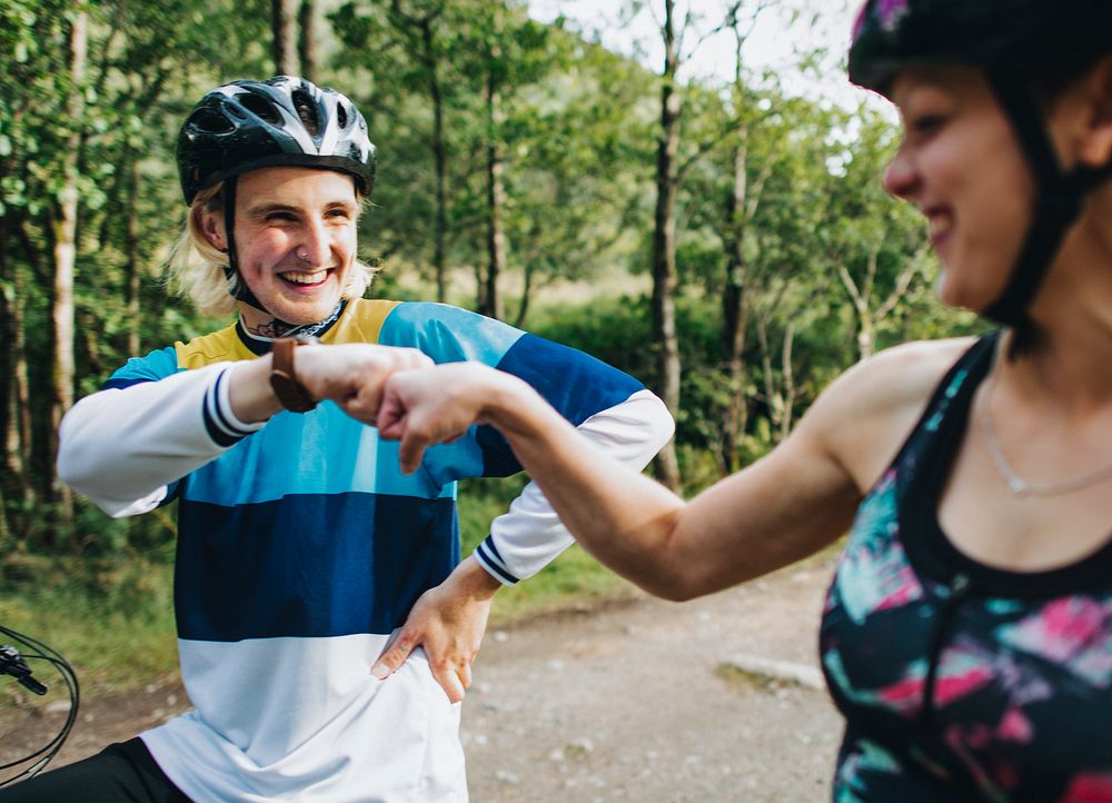 Cyclists giving each other a fist bump