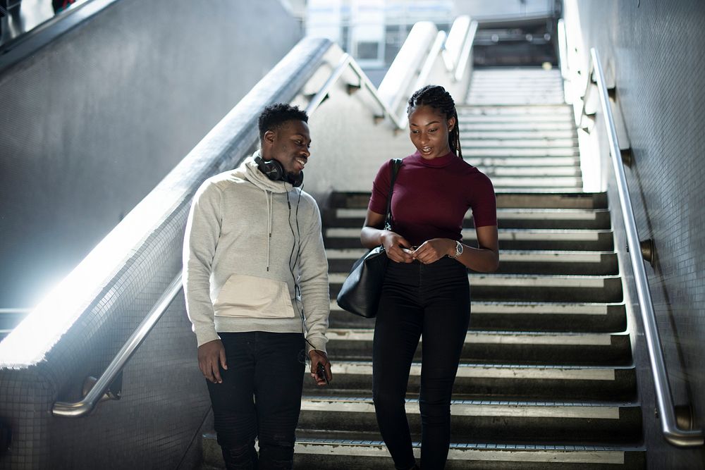 Couple walking down into the underground station