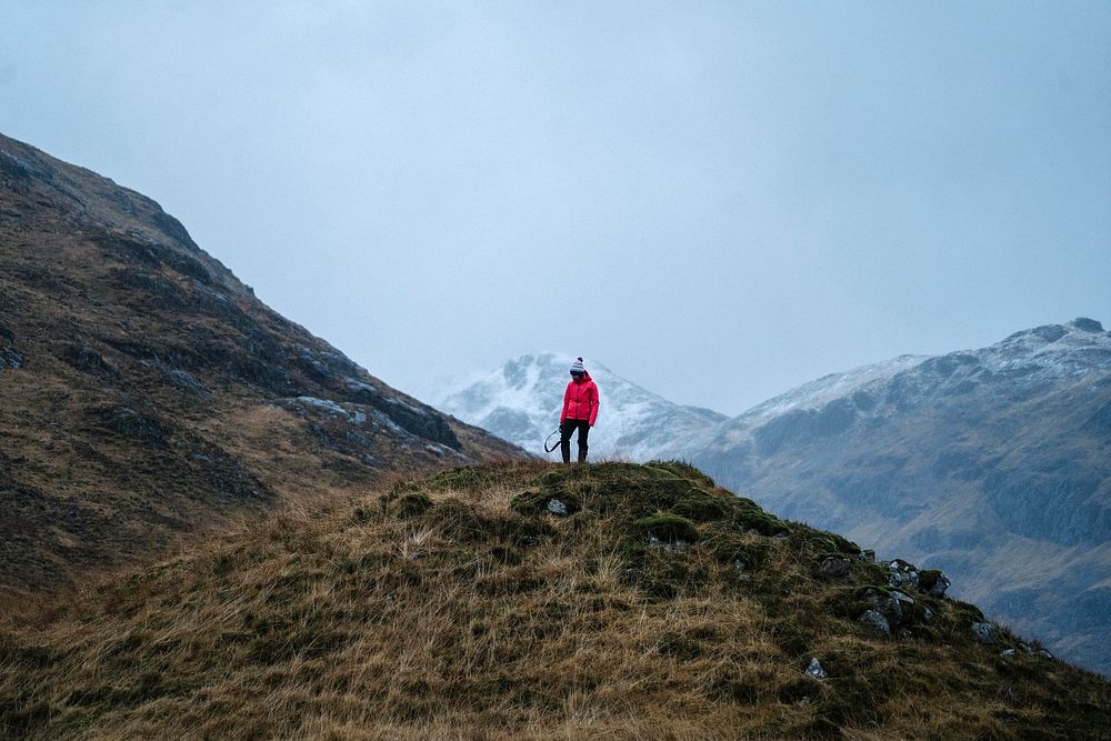 Female photographer on top of a hill at Glen Etive, Scotland