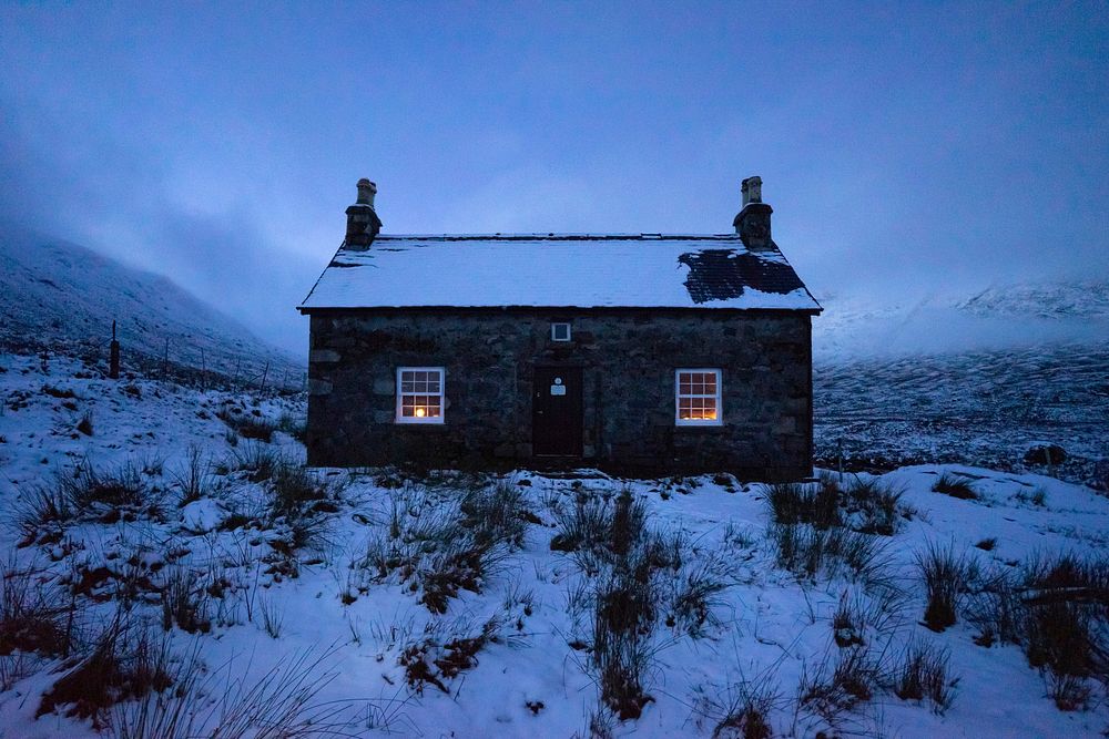House covered with snow on a misty day
