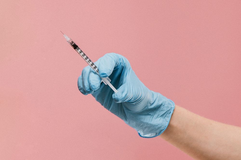 Nurse holding an injection syringe
