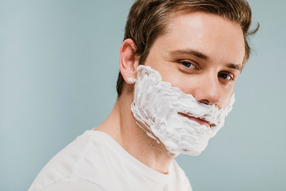 Young man with shaving cream on his face