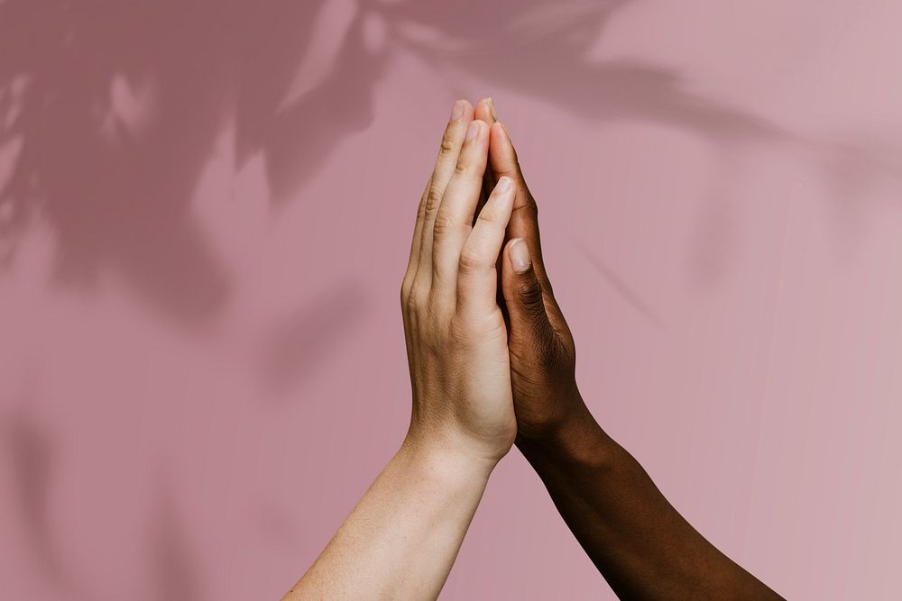 Diverse hands giving high five