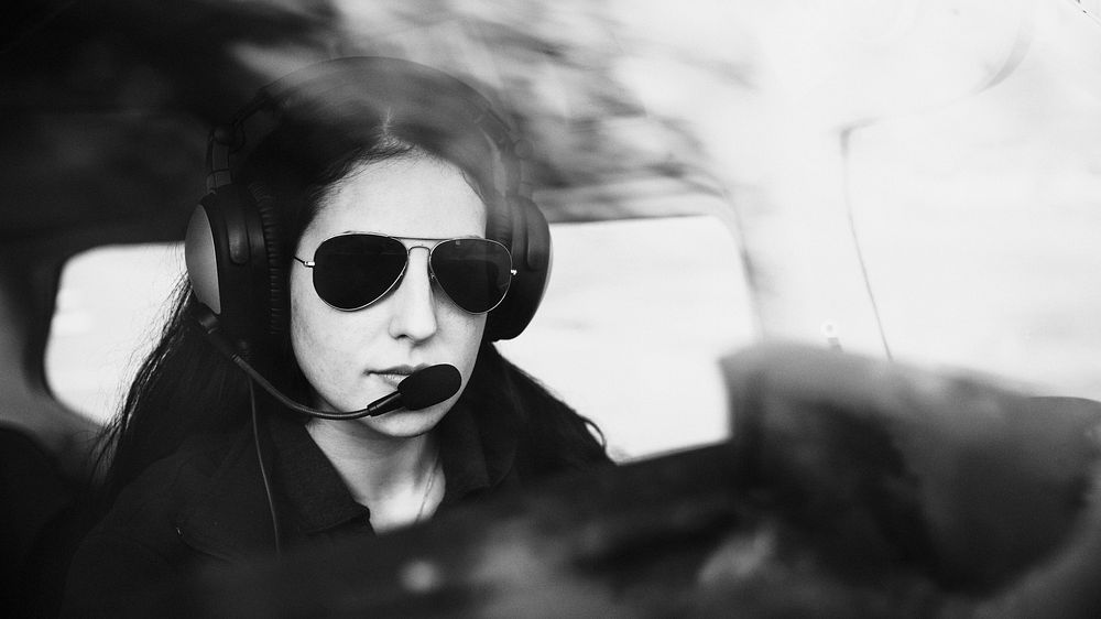 Aviator with headphones listening to the air traffic