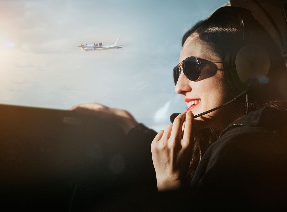 Aviator with headphones listening to the air traffic