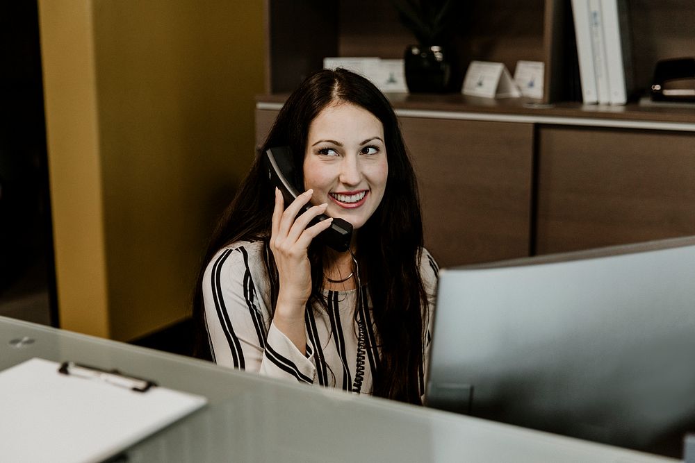 Happy receptionist  on the telephone