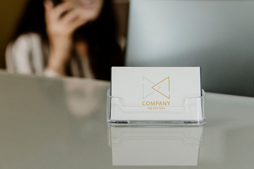 Receptionist sitting by the company name card