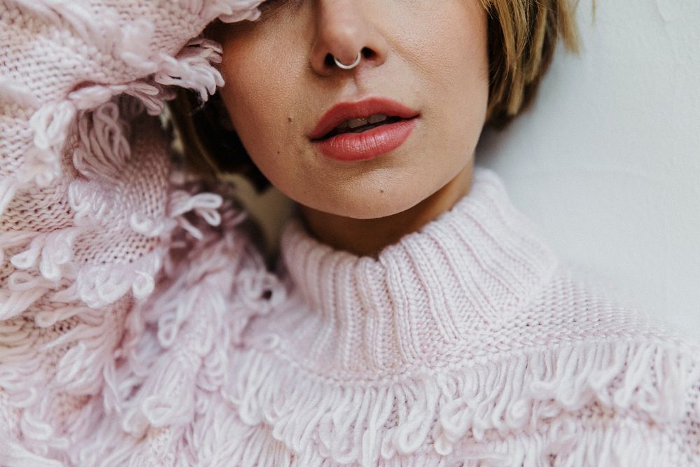 Portrait of a cheerful woman in a light pink sweater