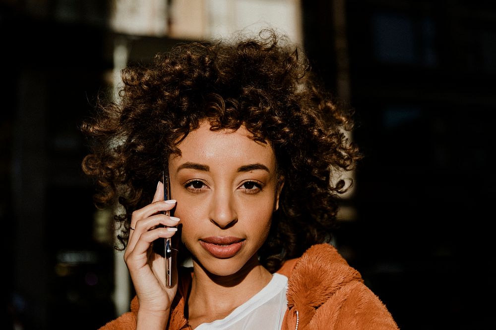 Black woman making a call in downtown