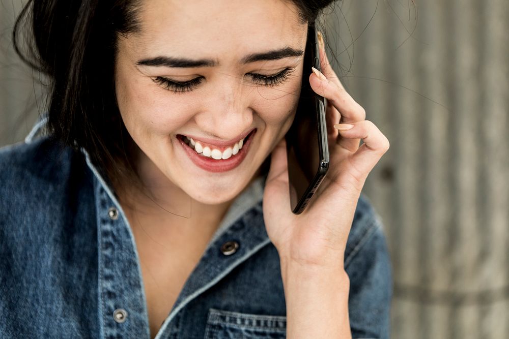 Cheerful female carpenter talking on a phone